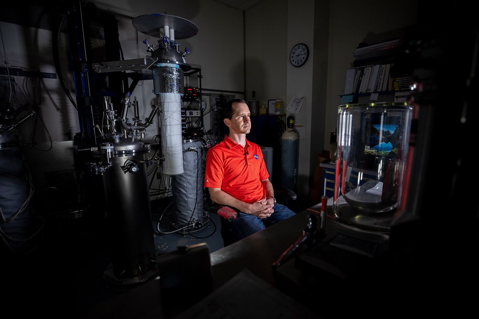 Engineer seated in a test laboratory surrounded by validation equipment
