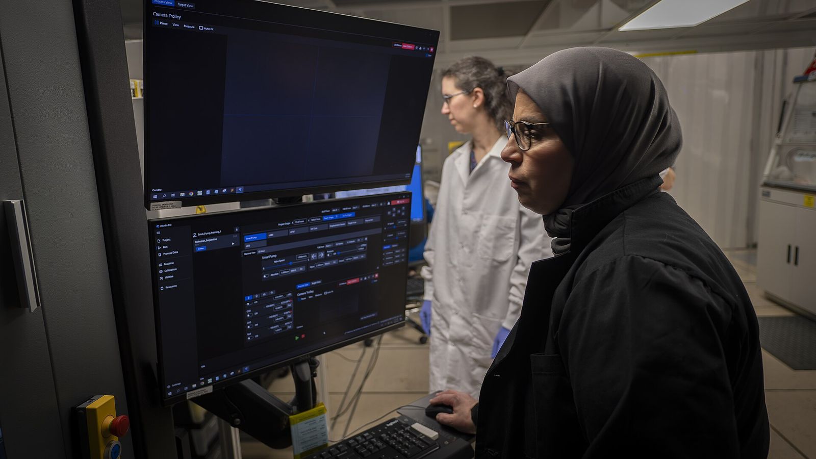 Engineers at a lab workstation reviewing live test data